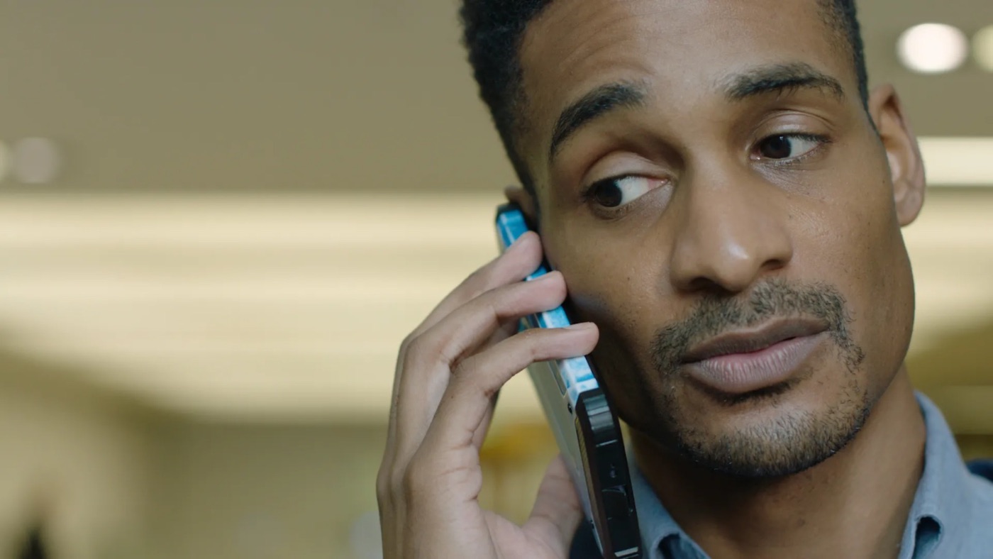 Cinematic commercial frame, actor on a phone in dramatic light, shot by Keith Ingram DoP
