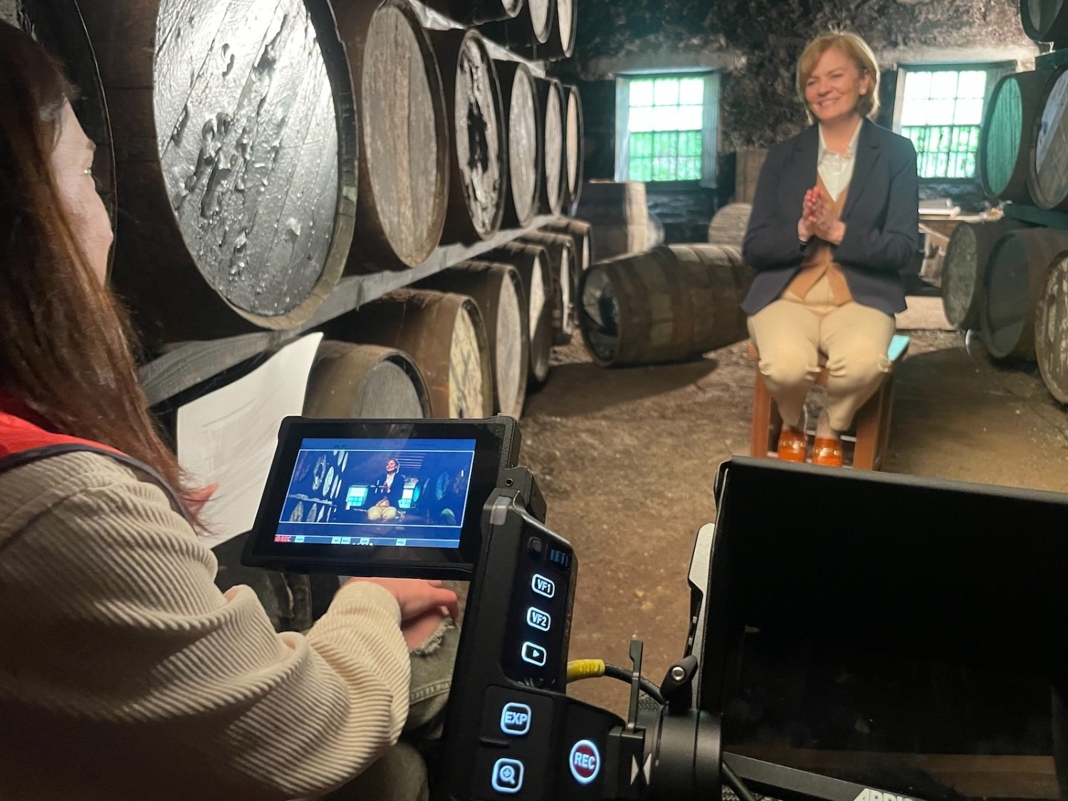 Keith Ingram filming an interview in a whisky distillery warehouse