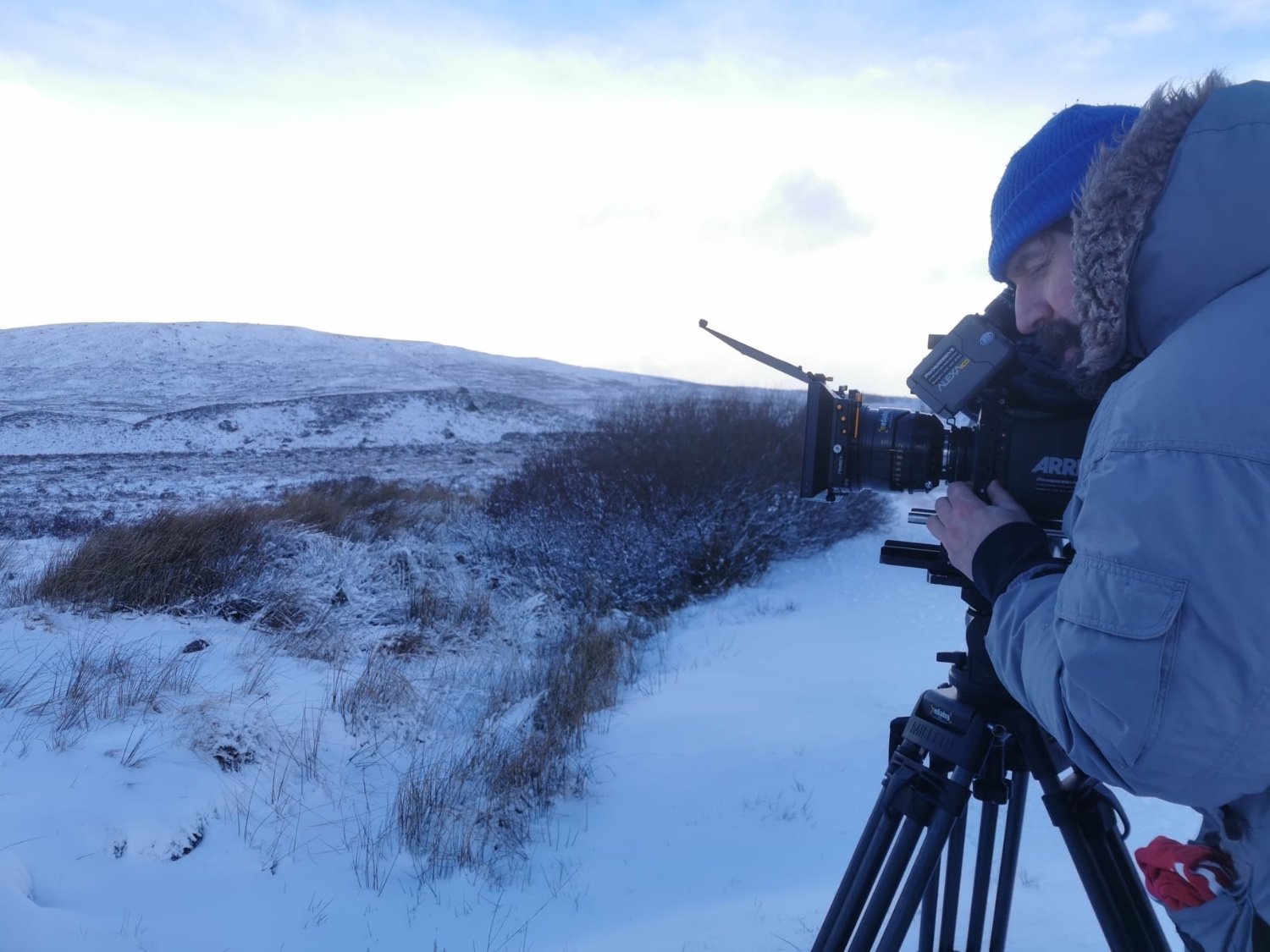 Keith Ingram operating an ARRI camera on a snowy Scottish Highlands location